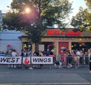 Crowd of customers outside front of restaurant