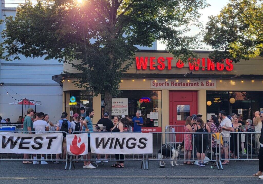 Crowd of customers outside front of restaurant