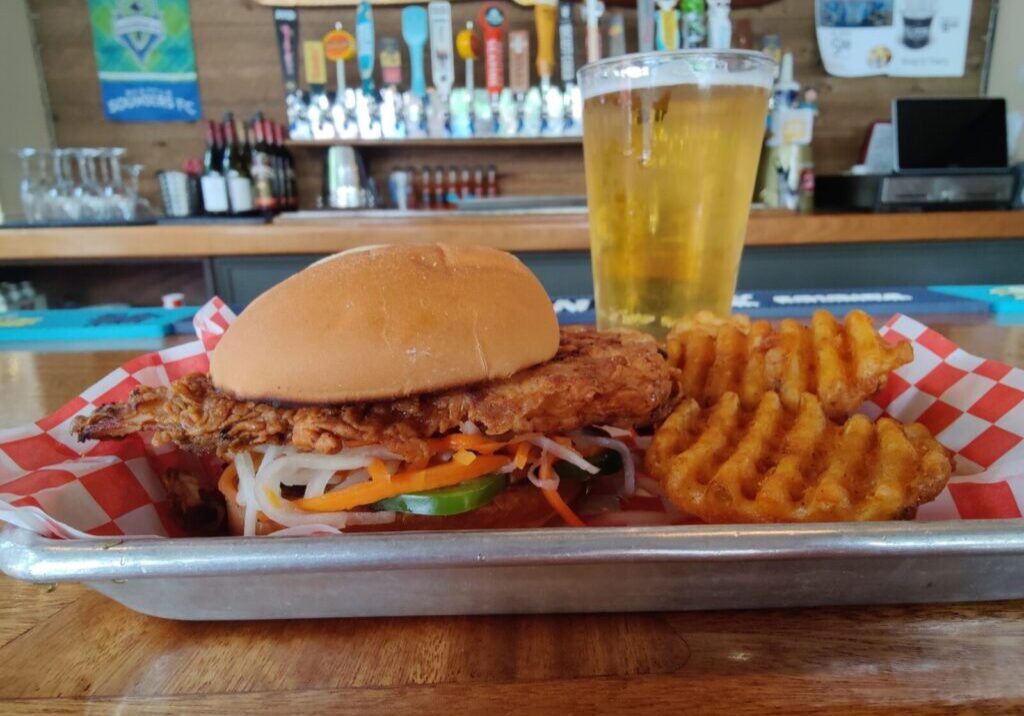 Hot Honey Crispy Chicken Sandwich, waffle fries and a cold beer